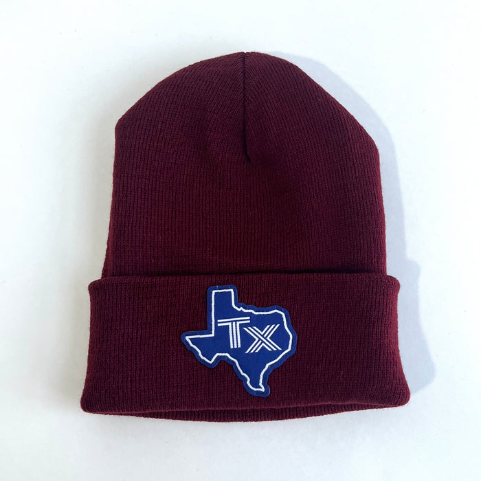 Blue Texas Silhouette Beanie featuring a maroon color and handstitched TX patch, perfect as a Texas themed gift, a Texas made gift, or a souvenir from Texas, ideal for fans of Dallas souvenirs and Texan gifts.