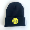 Smiley Face Beanie featuring a yellow patch on a stylish black knit cap, perfect as a Texas themed gift and a great way to show off your Texan pride with this Dallas souvenir.