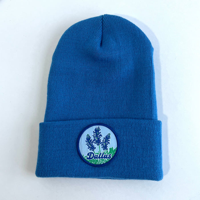 Bluebonnets Beanie featuring a hand-stitched patch with bluebonnet design, perfect as a Texas themed gift or souvenir from Texas. This cozy beanie is ideal for anyone looking for Texas Made Gifts or a dallas souvenir.