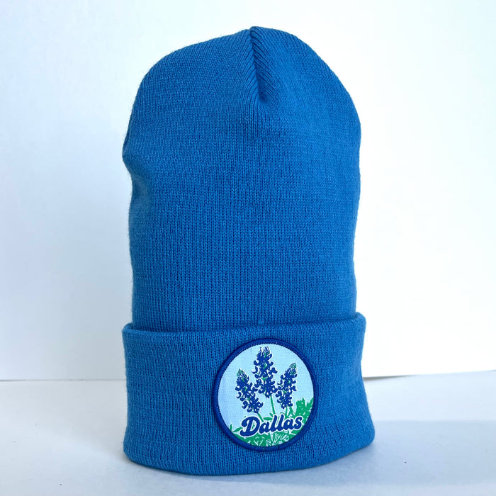 Side view of the Bluebonnets Beanie showcasing its vibrant light blue color and handcrafted patch, making it a great option for Texan gifts and souvenirs from Texas. A stylish accessory for anyone who loves Texas themed gifts.