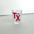 TX Shot Glass featuring bold red lettering, perfect for showcasing Texas pride. A great Texas themed gift and ideal for souvenirs from Texas, this 1.5 oz glass is a must-have for any collection of Texan gifts or Dallas souvenirs.