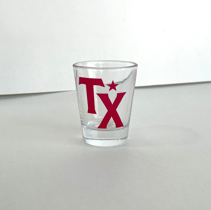 TX Shot Glass featuring bold red lettering, perfect for showcasing Texas pride. A great Texas themed gift and ideal for souvenirs from Texas, this 1.5 oz glass is a must-have for any collection of Texan gifts or Dallas souvenirs.