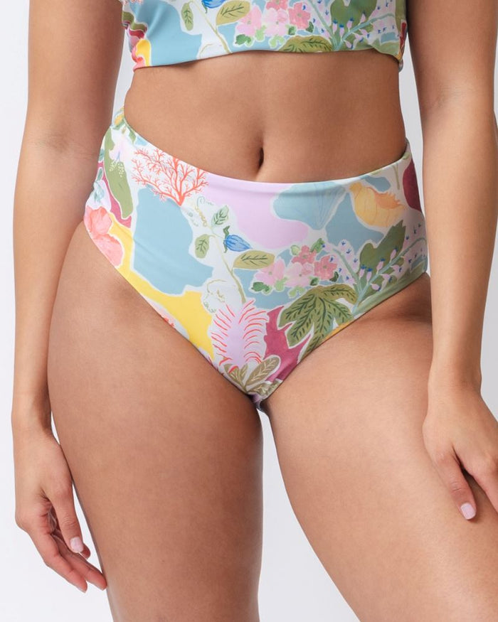Close up photo of a woman wearing a colorful seashell inspired high waist swim bottom