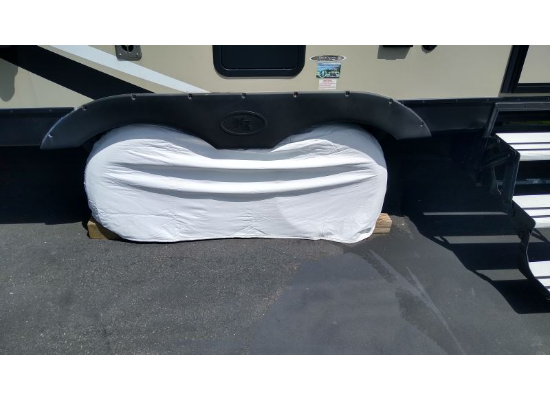White ADCO Double Axle Camper Tire Cover Fitted on RV Dual Wheels - Lifestyle View | United RV Parts