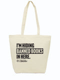 Canvas tote bag with the text "I'm Hiding Banned Books in Here" and the Dallas Public Library logo printed in black ink.