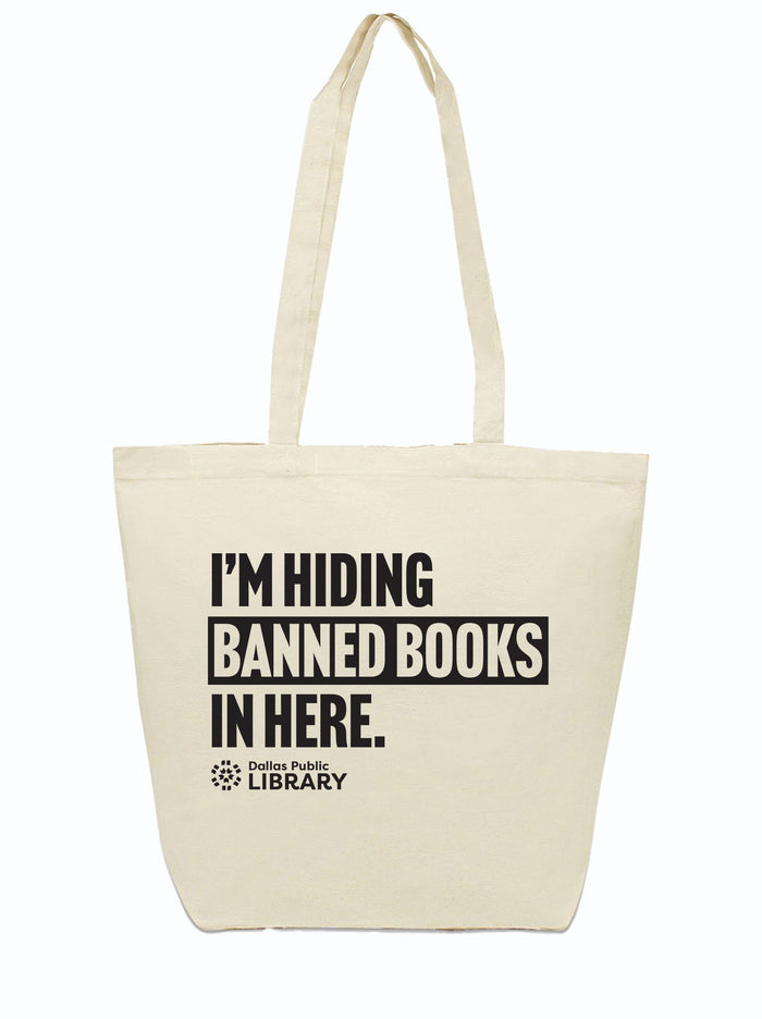Canvas tote bag with the text "I'm Hiding Banned Books in Here" and the Dallas Public Library logo printed in black ink.