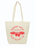 Bishop Arts Tote Bag featuring a bold red design with acorns and leaves, perfect for shopping trips or as a Texas themed gift. Made from 100% cotton canvas, this stylish tote also makes for a great Dallas souvenir and is an ideal choice for anyone looking for unique Texas Made Gifts and Texan gifts.