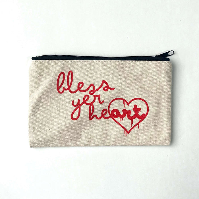 Bless Yer Heart Pencil Bag featuring bold red lettering on a neutral fabric background. Perfect as a Texas themed gift, this stylish and functional pencil case makes a great addition to your collection of Texas Made Gifts. Ideal for souvenirs from Texas or as a Dallas souvenir, it's a must-have for anyone looking for unique Texan gifts.