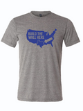 Gray tshirt with a graphic of the united states and text reading "build the wall here" with an arrow pointing to a line above Texas.