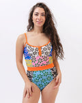 Photo of a woman wearing a multi-colored floral one-piece swimsuit