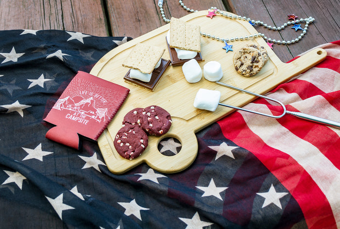 Camco 53089 Retro RV Bamboo Cutting Board Styled with S'mores and Cookies on American Flag - Lifestyle | United RV Parts