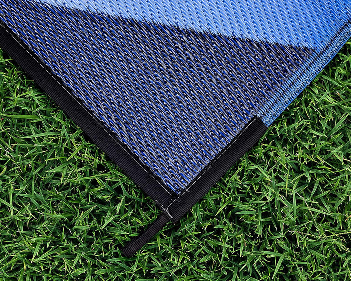 Blue Camco RV Patio Mat Folded Corner Showing Reversible Woven Texture Detail | United RV Parts
