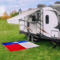 Camco Texas RV Patio Mat 42860 laid outside travel trailer - Lifestyle Shot | United RV Parts