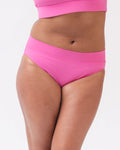 Photo of a woman wearing dark pink classic swim bottoms
