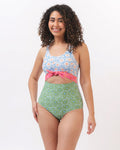 Photo of a woman wearing a blue and green floral knotted one piece swim suit