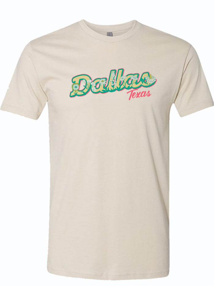 Cream tshirt with a graphic design of "Dallas Texas" text with wild flowers incorporated in the letters.