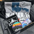 Dallas Gift Box featuring a Bullzerk Dallas Skyline Silhouette t-shirt and an assortment of Dallas-themed small products.