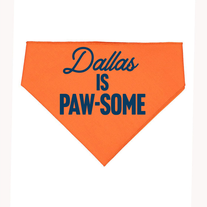 Dallas Is Pawsome Dog Bandana in vibrant orange featuring bold blue text. A perfect Texas themed gift for dog lovers, showcasing Texas Made Gifts and ideal for souvenirs from Texas, making it a great dallas souvenir and texan gift.