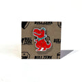 Dallasaurus Tex Enamel Pin displayed on a branded background, perfect as a Texas themed gift, a unique Texas Made Gift, and an ideal souvenir from Texas, showcasing Texas pride through this fun dallas souvenir and texan gifts.