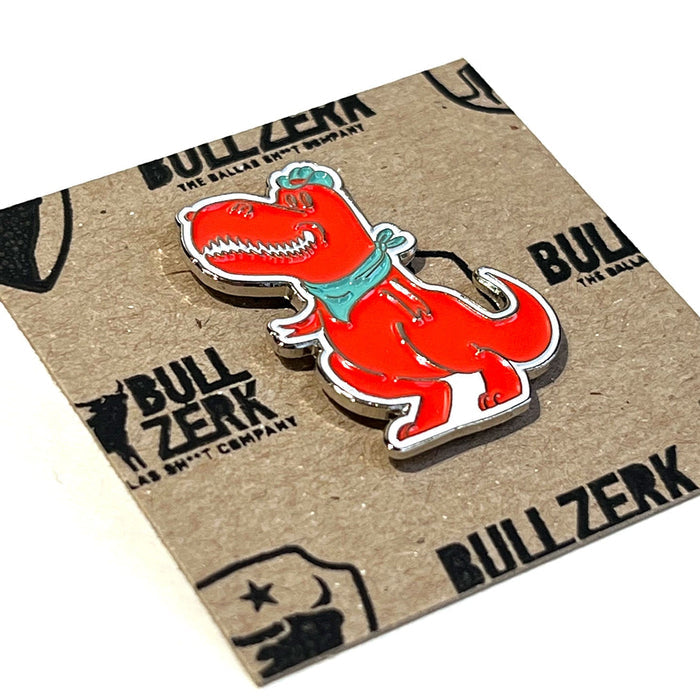 Close-up view of the Dallasaurus Tex Enamel Pin, featuring vibrant colors and a quirky design, making it a great Texas themed gift, a standout Texas Made Gift, and a memorable souvenir from Texas, ideal for dallas souvenir and texan gifts enthusiasts.