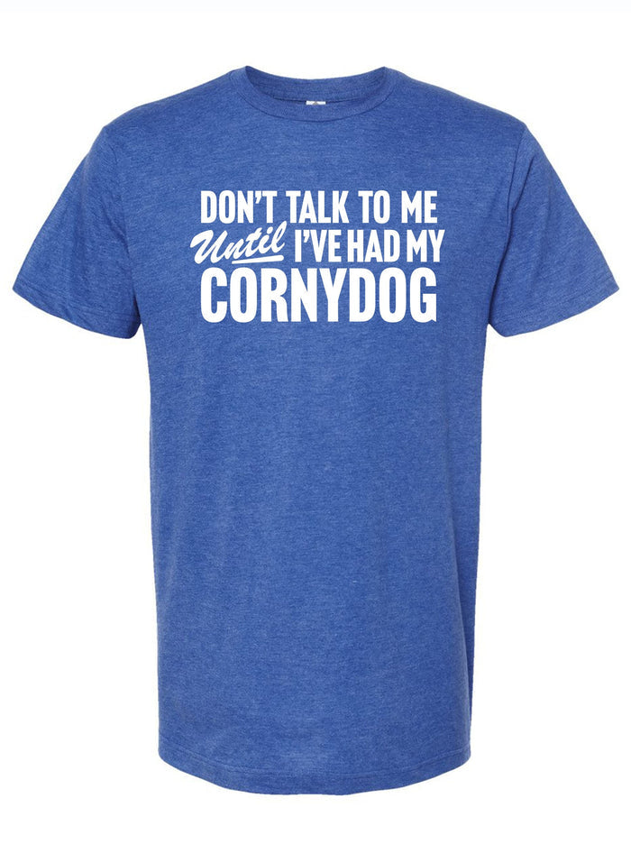 Blue unisex tee featuring the phrase 'Don't Talk To Me Until I've Had My Cornydog,' perfect for fans of Texas culture. This shirt makes a great Texas themed gift, ideal for anyone looking for Texas Made Gifts or souvenirs from Texas, capturing the spirit of Dallas and offering fun options for Texan gifts.