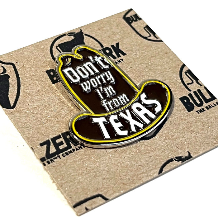 Close-up of the Don't Worry Enamel Pin with cowboy hat design and 'Don't worry I'm from Texas' text, ideal for Texas themed gift, Texas Made Gifts, souvenirs from Texas, dallas souvenir, and texan gifts.