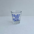 Hold My Beer Shot Glass featuring a vibrant blue design, perfect for Texas themed gifts, Texas Made Gifts, souvenirs from Texas, and a great Dallas souvenir or Texan gift. This 1.5 oz glass shot glass stands approximately 2.25 inches tall.