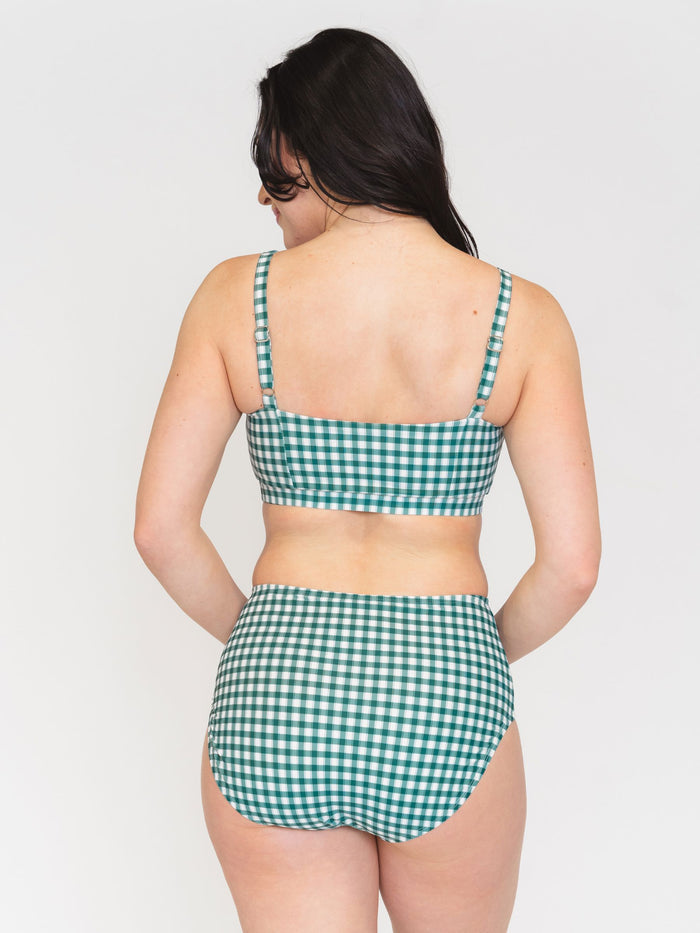 Back view of a Woman wearing a green checkered bikini set on a white background