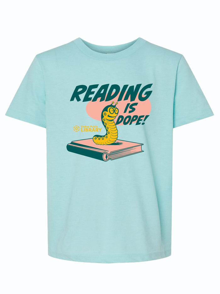 Kids t-shirt featuring the phrase 'Reading Is Dope!' with a playful bookworm design, perfect as a Texas themed gift. This stylish shirt supports local libraries, making it a unique Dallas souvenir and an excellent choice among Texas made gifts for young readers.