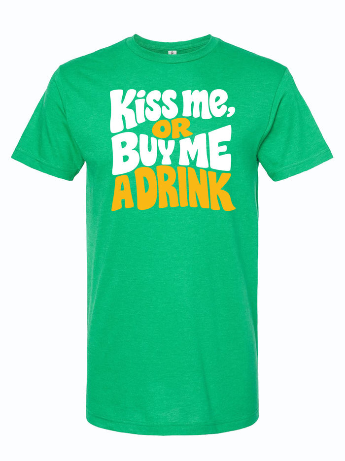 Green tshirt with graphic design of text reading "kiss me, or buy me a drink" in yellow and white bubble letters.