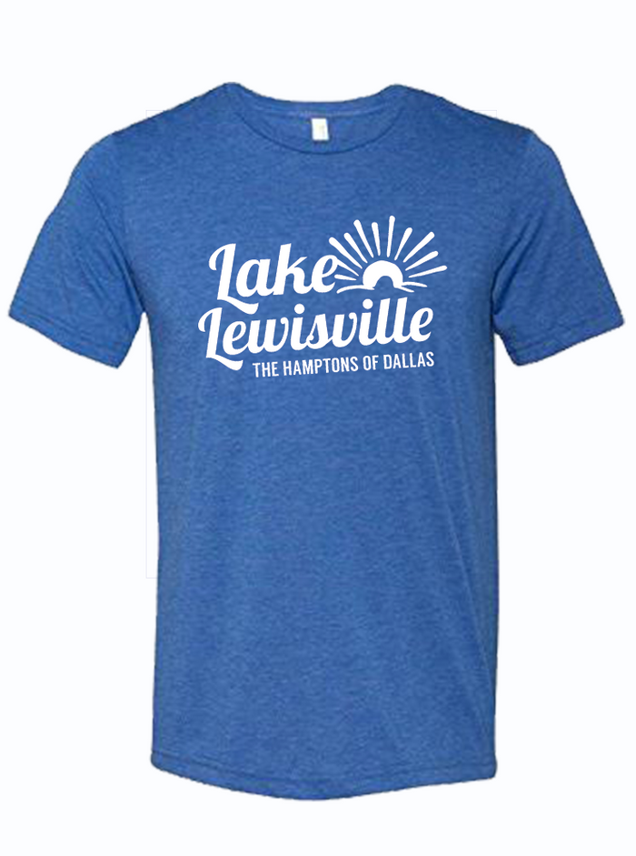A royal blue shirt that reads "Lake Lewisville the Hamptons of Dallas" in white ink. Features a graphic of a sun over waves.