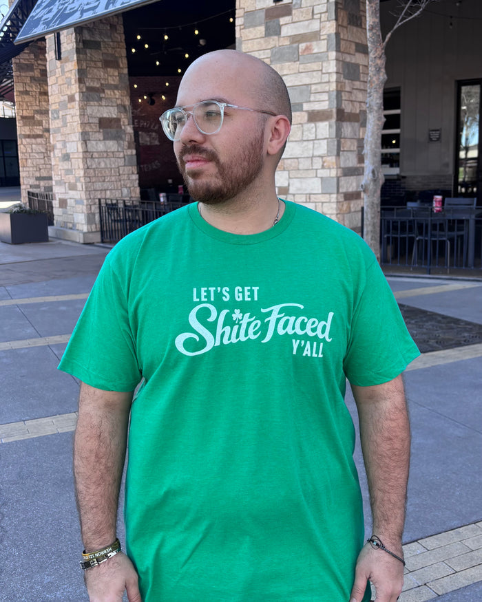 Man wearing a Bullzerk "Let's Get Shite Faced Y'all" tshirt, standing outside.