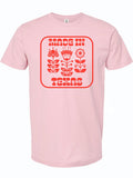 Pink tshirt with a graphic design of red flowers and text reading "Made In Texas" in red letters.