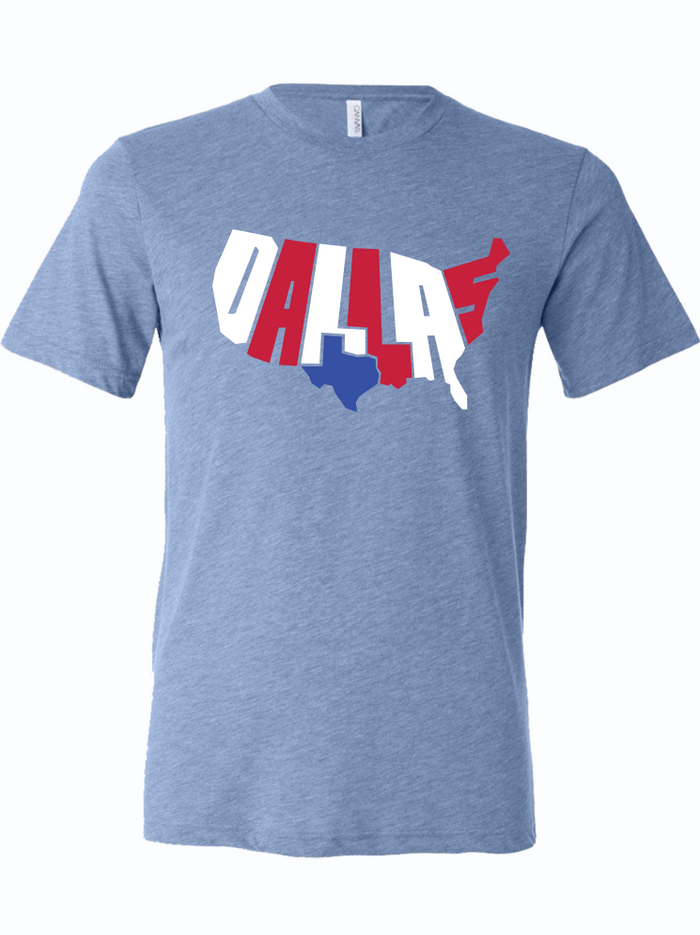Light blue tshirt with graphic design of the shape of the United States filled in with text reading "DALLAS" and the shape of Texas filled in solid blue.