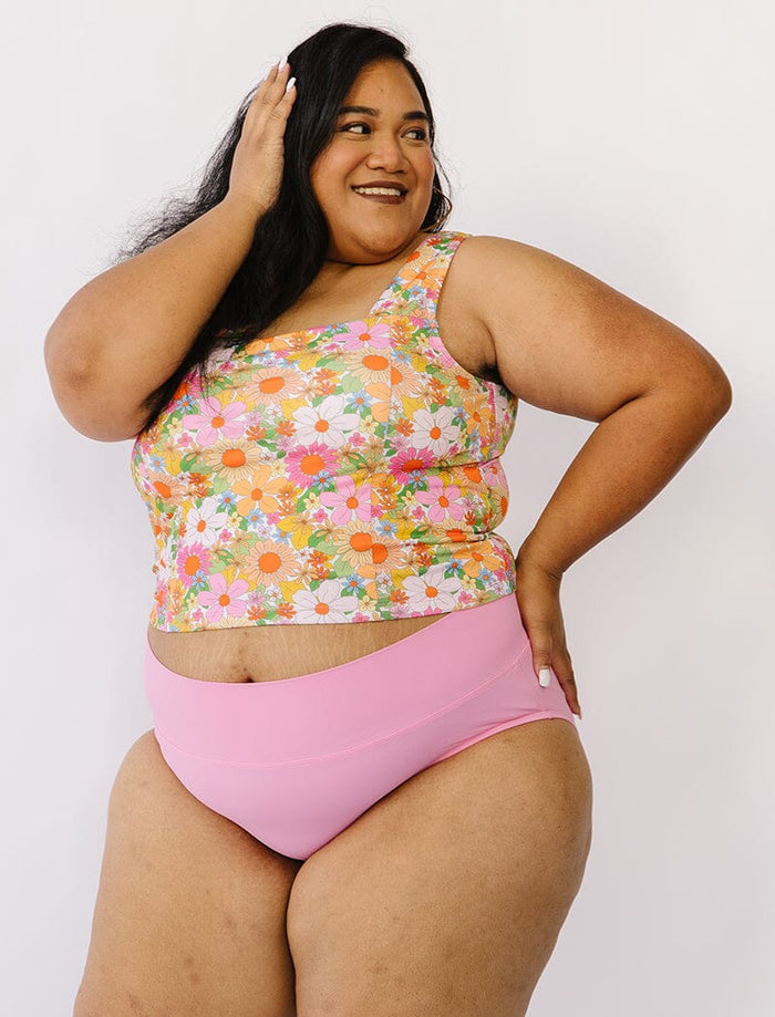 Photo of woman wearing multi colored floral square neck swim top with pink swim bottoms
