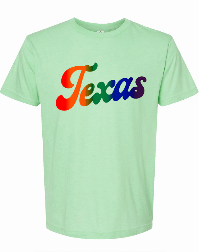 Mint green tshirt with graphic of the word "TEXAS" in a script font filled in with a rainbow gradient across the letters.