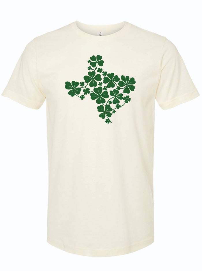 Cream tshirt with graphic design of the shape of Texas filled with green shamrocks.