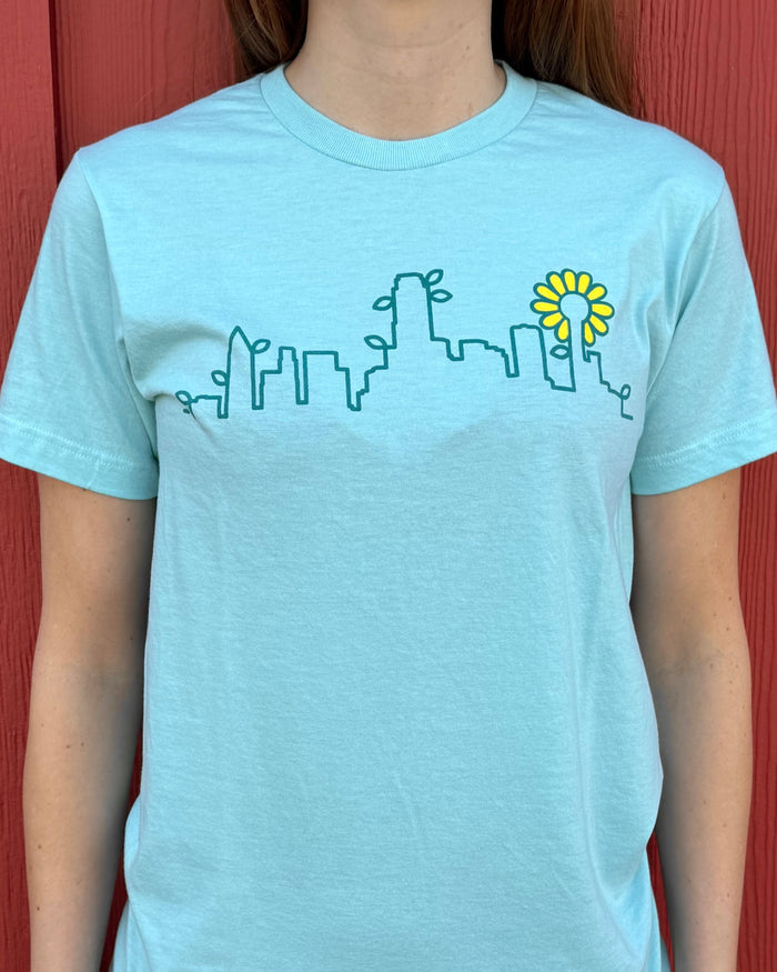 Close-up photo of a person wearing the Skyline Plant tshirt.