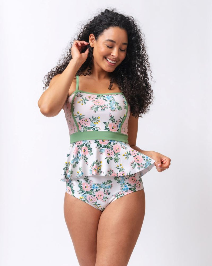 Photo of a woman wearing a pink and white floral swim top with pink and white floral high waist swim bottoms