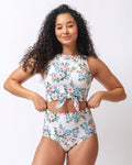 Photo of a woman wearing a pink and white floral cropped swim top with pink and white floral high waist swim bottoms