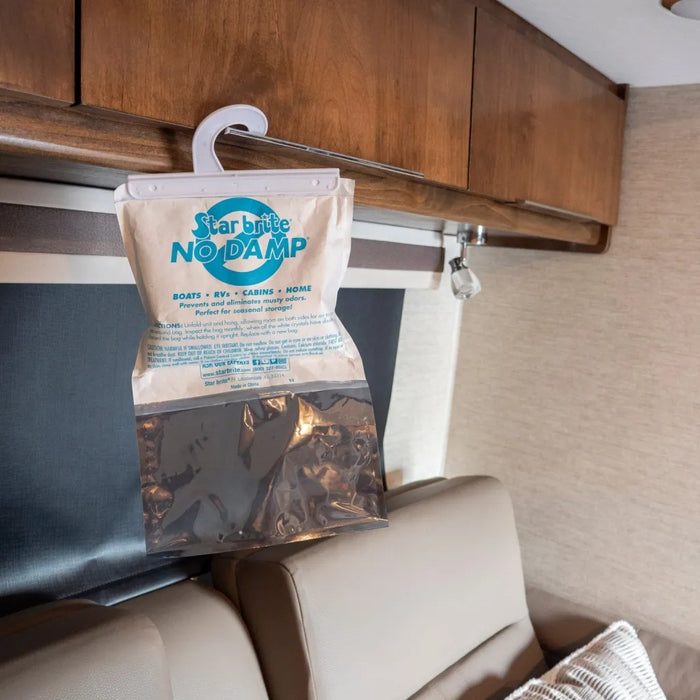 Star Brite No Damp Dehumidifier Bag Hung on RV Overhead Cabinet Rail - In Use Close-Up | United RV Parts