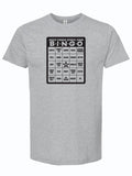 State Fair Bingo graphic printed on a grey unisex fine jersey tee, perfect as a Texas themed gift. This shirt features a fun bingo layout inspired by popular state fair foods, making it an ideal souvenir from Texas. Great for anyone looking for Texas Made Gifts, especially as a Dallas souvenir or a tribute to Texan gifts.