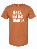 Rust orange tshirt with text reading "TEXAS: BETTER THAN OK" in white letters.
