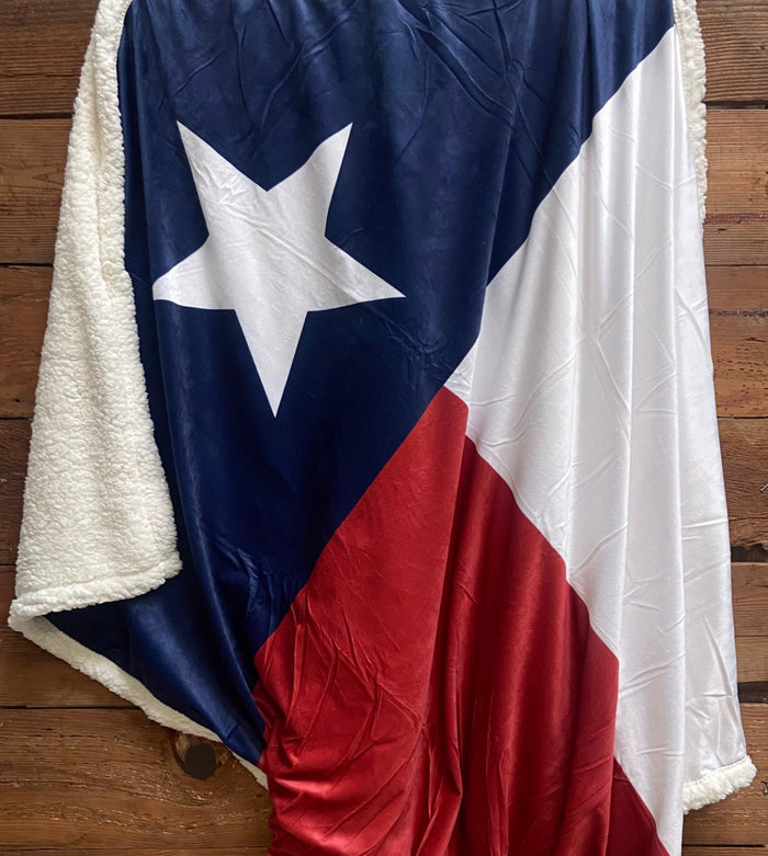 Cozy Texas Blanket featuring the Texas flag design, perfect for cozying up in style. Ideal as a Texas themed gift or a Dallas souvenir, this soft fleece blanket is a must-have Texas made gift for any Texan.