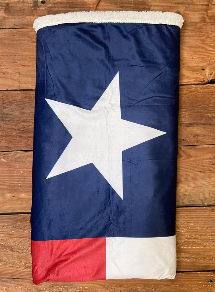 Texas Blanket rolled up, showcasing its vibrant Texas flag colors. This comfortable blanket makes for a unique Texas themed gift and a great souvenir from Texas, perfect for anyone looking for Texan gifts.