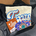 A Texas Gift Box featuring a Bullzerk Texas Script t-shirt and an assortment of Texas-themed small products.