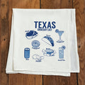 Texas Groceries Tea Towel featuring a playful design with Texas food items like steak, tacos, and sweet tea, perfect as a Texas themed gift, Texas Made Gifts, and a unique Dallas souvenir for those who love Texan gifts.
