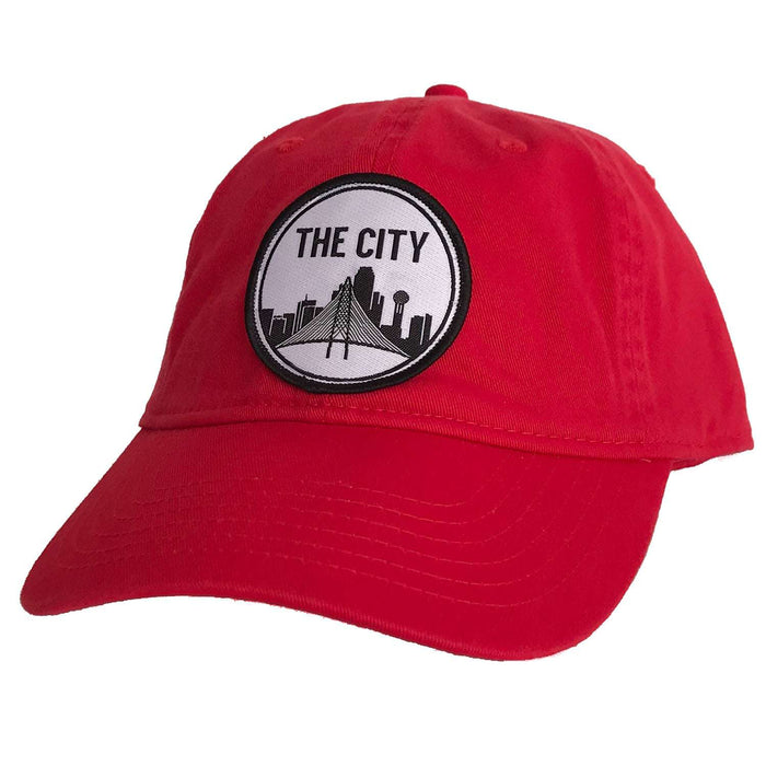 The City Patched Cotton Hat in red, adorned with an eye-catching embroidered patch, perfect for representing Texas everywhere you go. This hat serves as a fantastic Texas themed gift, a memorable choice for Texas Made Gifts, and a unique souvenir from Texas, making it a great Dallas souvenir and Texan gift.