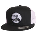 The City Patched Flat Bill Hat featuring a black and white design, perfect for anyone looking for a cool Texas themed gift. This snapback hat showcases a stylish city skyline patch, making it a great Texas Made Gift, ideal for souvenirs from Texas, especially for Dallas enthusiasts who love unique Texan gifts.