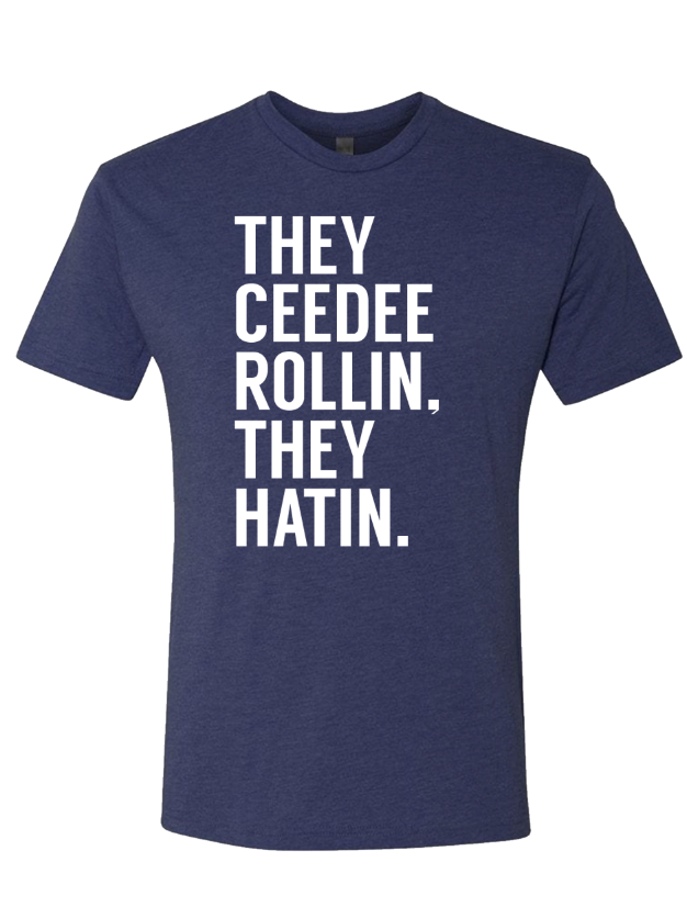 Denim blue tshirt with text reading "The Ceedee Rollin, They Hatin" in white letters.